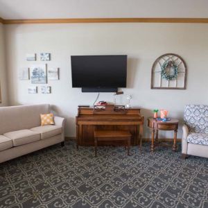Sunset Ridge Memory Care - Common Area with Television and Piano